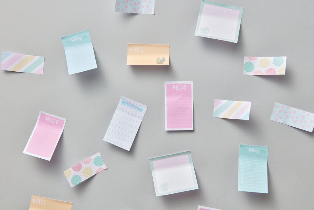 Assorted pastel sticky notes scattered on a neutral background.
